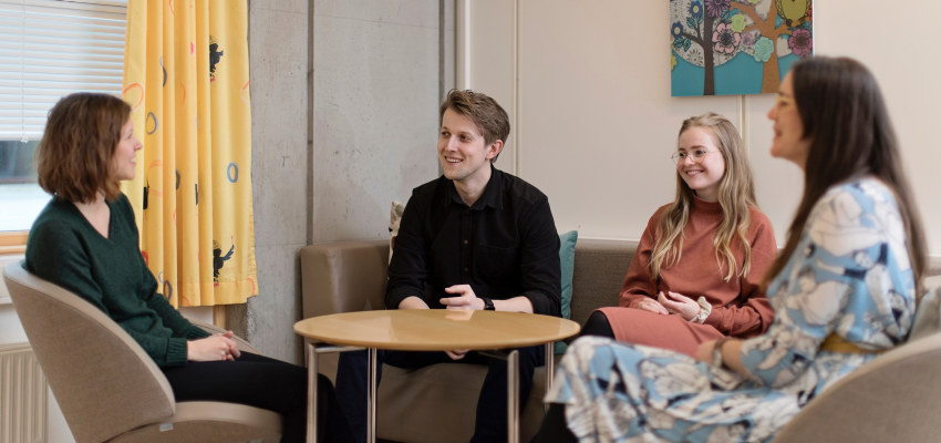 A group of people talking. Photo.